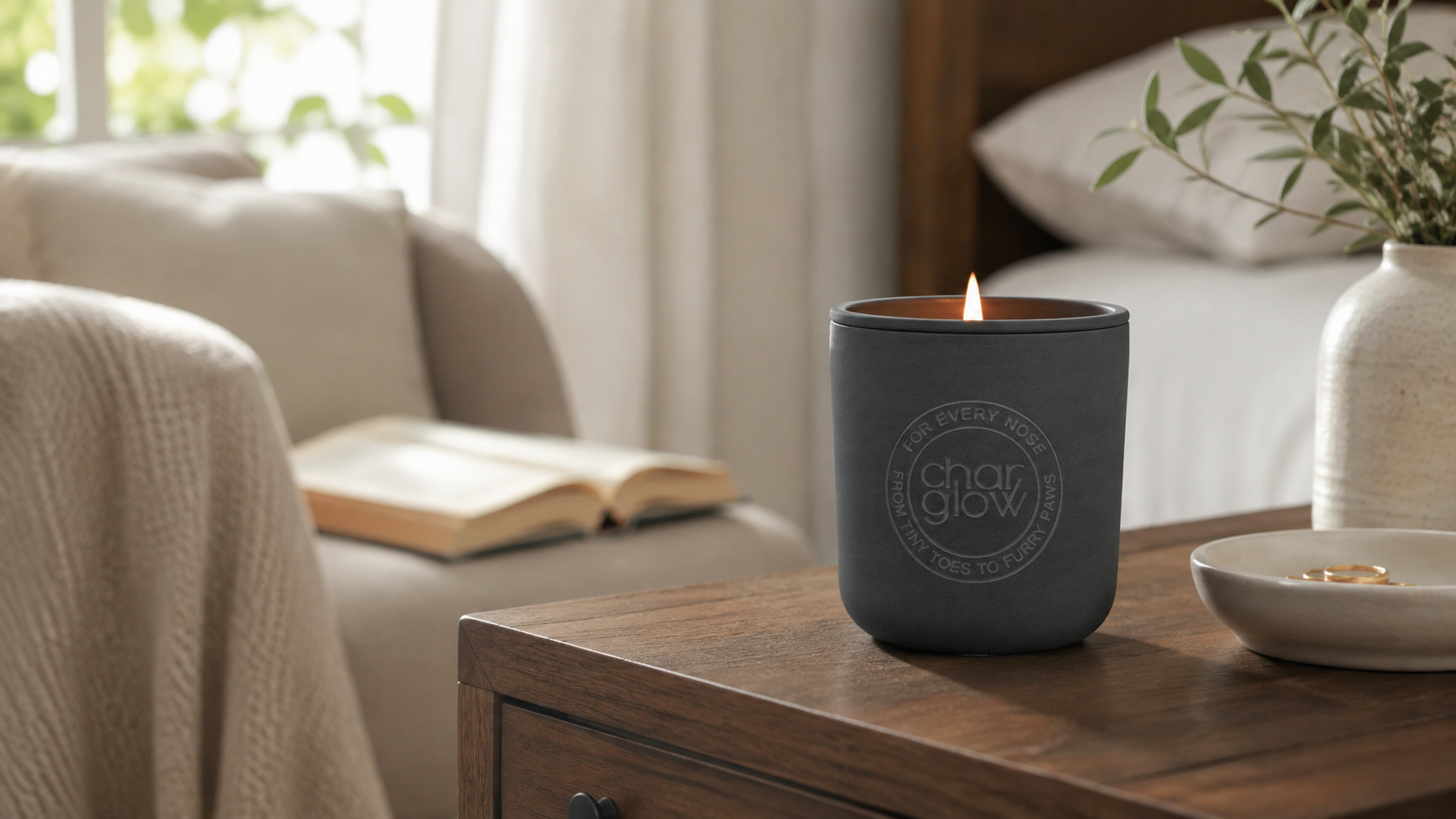 Lightly scented CharGlow Signature candle in a quiet reading nook with soft natural light