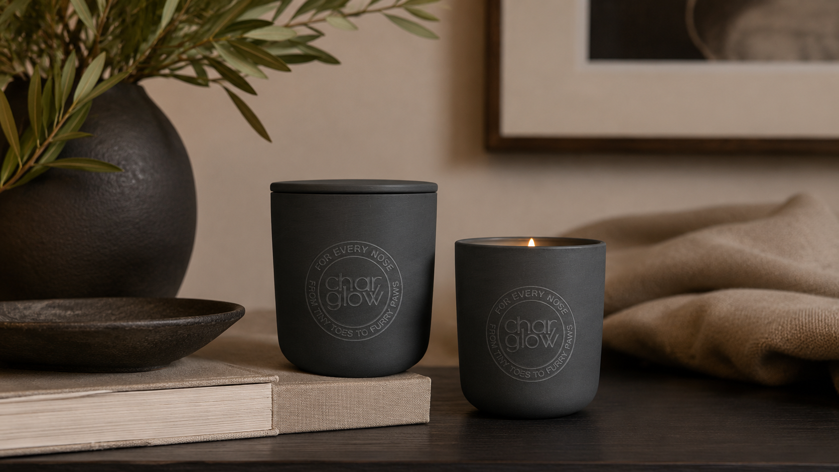 harGlow Escape and Signature candles displayed together in a warm neutral home interior